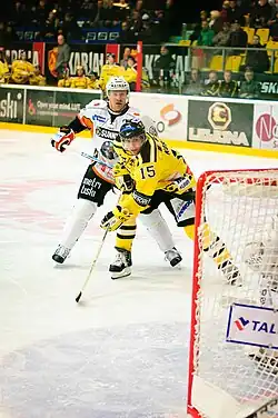 Finnish ice hockey players Petri Koskinen of SaiPa Lappeenranta and Jukka Laamanen of HPK Hämeenlinna battling for the puck in the Finnish SM-liiga.