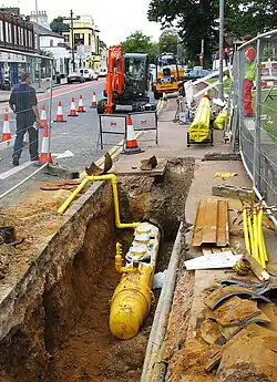 Image 6Polyethylene plastic main being placed in a trench (from Natural gas)