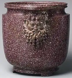 Roman era Egyptian porphyry vessel with masks of Silenus