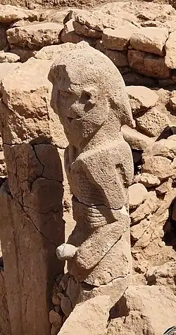 Karahan Tepe anthropomorphic statue (2.3 meters), naked and holding phallus with both hands.[9]