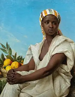 Portrait of a Black woman in loose fitting white robe and wearing an orange striped headwrap