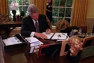 President Bill Clinton at his desk in the Oval Office