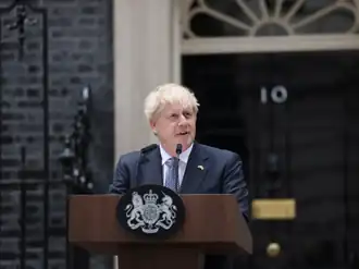 Johnson outside 10 Downing Street, standing at a wooden lectern