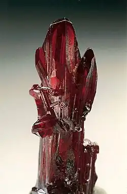 Proustite (long prismatic crystal) – Chañarcillo, Copiapo Province, Chile. Specimen height is 4&nbsp;cm.