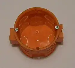 68 mm round outlet box for installation in a brick wall, with connectors on each end to chain multiple boxes together