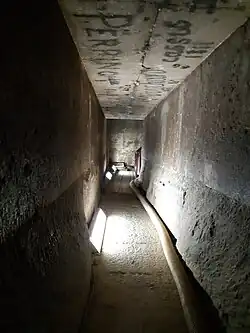 Passage connecting the second and burial chamber, with the lower walls and floor showing damage thought to be caused by tomb robbers