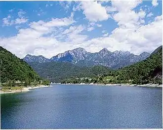 A body of water with mountains in the distance.