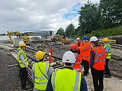 Representatives from Dudley Council and Coventry City Council standing around and looking at a VLR test track