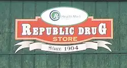 Republic Drug Store logo painted in red and white on a green background