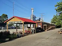 Restored rail cars and statue of Garfield on the Sweetser Switch Trail