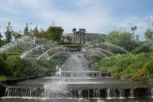 The Palazzo dello Sport seen from the waterfalls of the lake