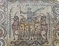 Roman mosaic of a victorious charioteer, victory palm he carries in his left hand.