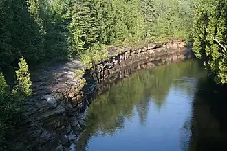 Rock faces of sedimentary Trenton Group limestones, from bridge on Route des Lefebvre