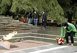 President Salome Zourabichvili laying flowers at the memorial.
