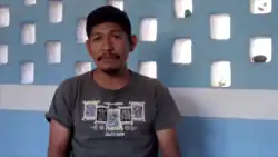 Flores Soberanes stands in front of a wall.