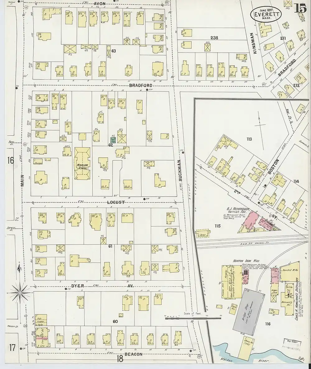 A section of an old property map, showing a small railroad station next to a three-track rail line