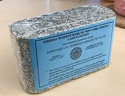 Shredded and briquetted US dollar notes from the Federal Reserve Bank of New York (approx.&nbsp;1000 pieces, 1&nbsp;kg)