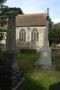 Side view of the chancel, an obelisk and the war memorial of Church of S.S. Peter & Paul, 2014.