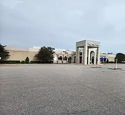 The front entrance of Signal Hill Mall, a concrete building bearing a sign reading "Signal Hill Mall".