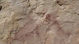 A cave painting of a horse in red ochre