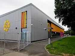 photograph of a grey building with 'Yr Hyb' logo