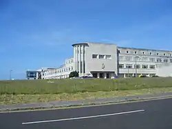 a long four-floor grey building on Portland