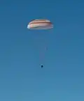 Soyuz TMA-07M descending with its main parachute deployed.