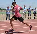 Special Olympian Diona Bell dashes by a group of U.S. Airmen to win the gold medal in the 100-meter run at the Mississippi Special Olympics Summer Games, hosted by Keesler Air Force Base (AFB) in Biloxi, Miss. 110514-F-BD983-011