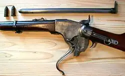 The Spencer repeating rifle with the breech open. Before the breechblock carrier can "roll" downward, the breechblock must fall vertically to clear the receiver.