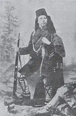 Woman wearing a Chetnik guerrilla uniform and holding a rifle