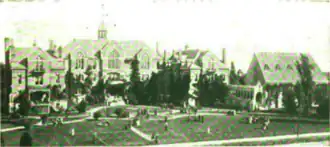 B&W exterior photo of a school campus with several buildings