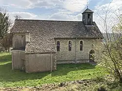 A cotswold stone simple chapel with a small bell turret.