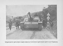 Soldiers surrounding a tank