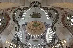 The Süleymaniye Mosque (1550–7), evokes the Hagia Sophia's design with a central dome and two semi-domes.[100]