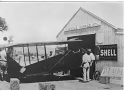 Windle's Garage on Todd Mall, with the Gold Quest II out the front (this plane was used in the search for Lasseter, circa 1950s