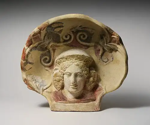 Etruscan antefix from Cerveteri of a maenad wearing an elaborate diadem and grape-cluster earrings, The MET