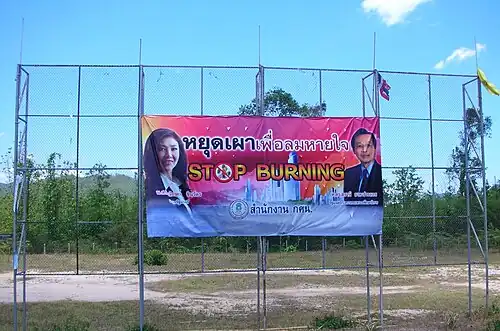 Sign put up by the Thai government by Route 1 near Tham Pha Thai National Park warning against deliberately setting off forest fires in the mountains