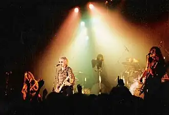 The Cross on stage in Germany, 1990. L-R: Clayton Moss, Roger Taylor and Peter Noone.