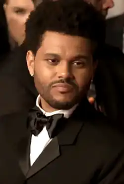 The Weeknd glancing towards a camera