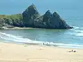 The formation of three peaks which give Three Cliffs Bay its name
