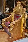 Empire throne; by Bernard Poyet and François-Honoré-Georges Jacob-Desmalter; 1805; carved and gilded wood, covered in red velvet with silver embroidery; 160 x 110 x 82&nbsp;cm; Musée des Arts Décoratifs[65]