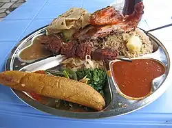 Image 18Traditional Tanzanian food consisting of pilau kuku (seasoned rice with chicken), mishkaki (grilled meat), ndizi (plantain), maharage (beans), mboga (vegetables), chapati (flatbread) and pili pili (hot sauce) (from Culture of Tanzania)