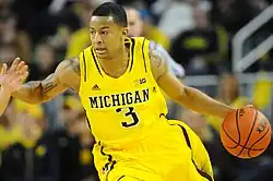 Player in yellow uniform, dribbling