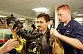A U.S. Navy PO2 assisting a Pakistan Navy lieutenant with the firefighting gear during the Exercise Inspired Siren in the Indian Ocean in 2002.