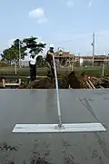 Smoothing concrete with a large concrete float, or bull float