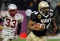 Midshipmen slot back Eric Roberts and Lobos linebacker Fola Fashola, 4th quarter