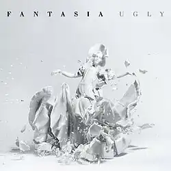 An image of a shattered white ceramic girl with the title of the single and the artist's name on the top.