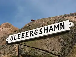 A sign that reads “Ulsbergshamn” taken in the harbour of Ulebergshamn.