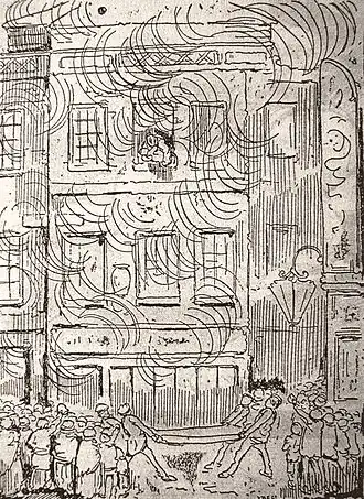 A three-storey building engulfed in flame, surrounded by a crowd. Four men on the pavement hold a mattress in front of the building. A woman leans through the window on the top floor holding a small child in her arms.