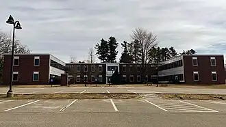Freeport Hall, a large U-shaped building made primarily of brick. Freeport Hall is the primary academic building at Unity Environmental University at Pineland.